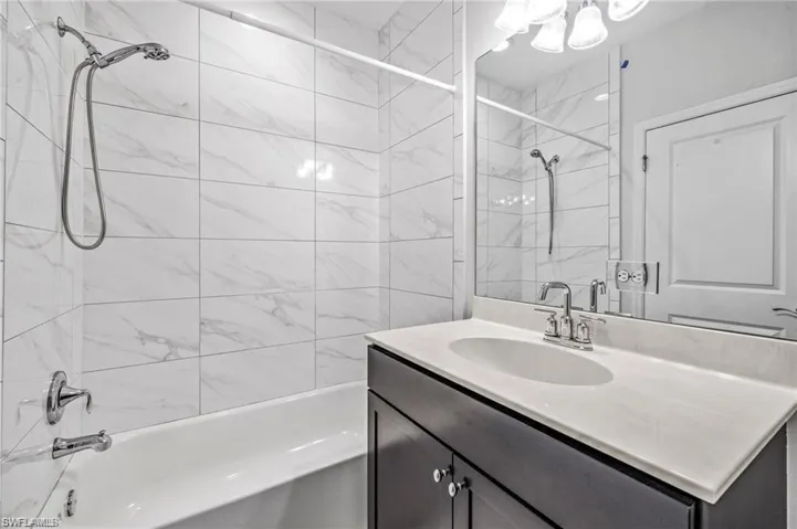 Full bath featuring vanity and shower / tub combination