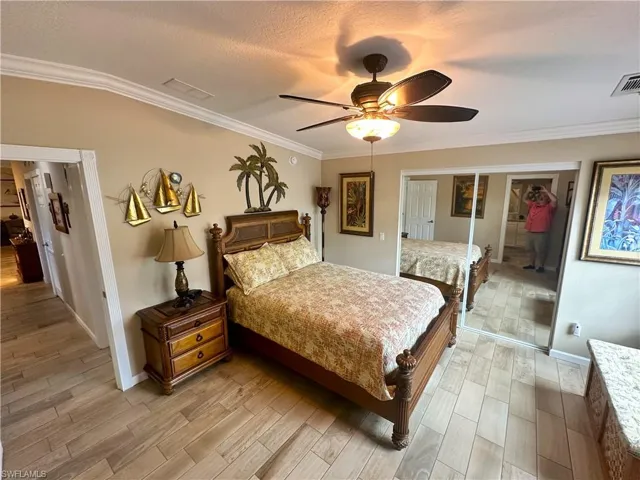 Primary Bedroom with ceiling fan, hardwood / wood-style flooring