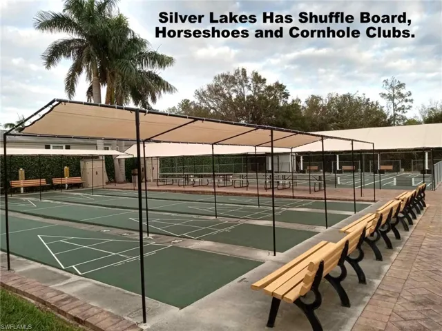 View of community featuring tennis court