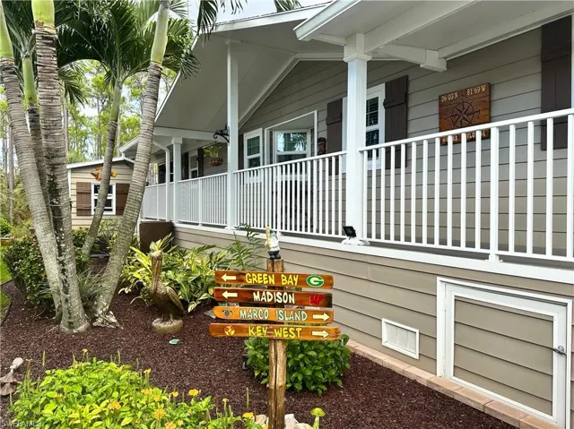 Front/ Side View of property exterior featuring covered porch and landscaping