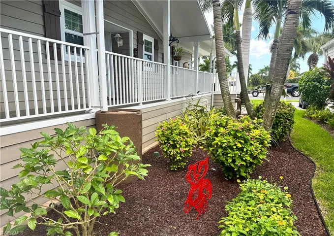 Rear / Side View of property exterior featuring covered porch and landscaping