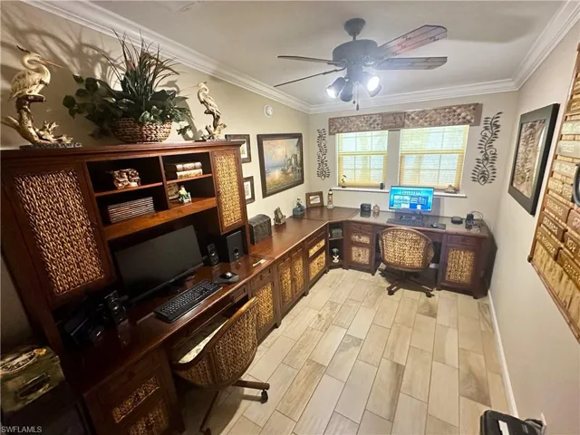 Home office featuring light hardwood / wood-style floors, ornamental molding, and ceiling fan
