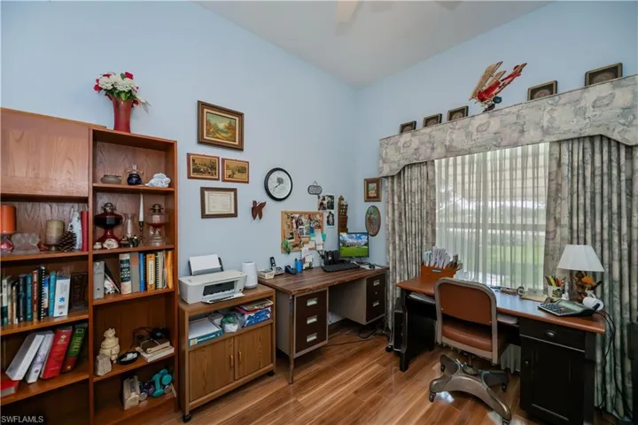 Office space with a ceiling fan and wood finished floors