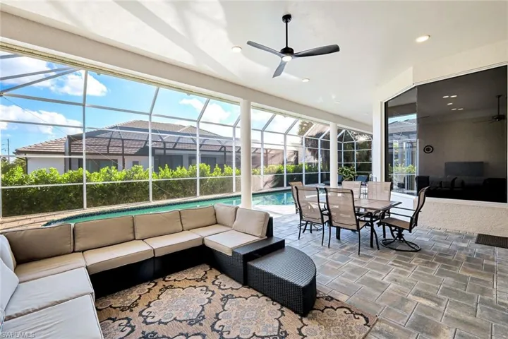 View of patio / terrace featuring ceiling fan, outdoor lounge area, a lanai, and a sunroom