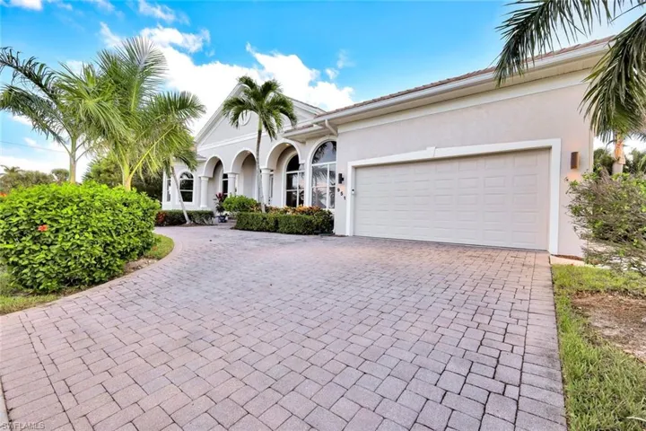 Mediterranean / spanish home with decorative driveway, stucco siding, and an attached garage