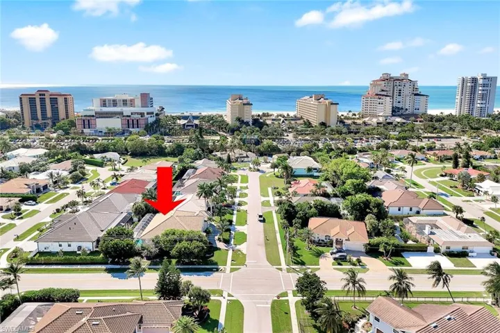 Aerial view of residential area featuring a nearby body of water