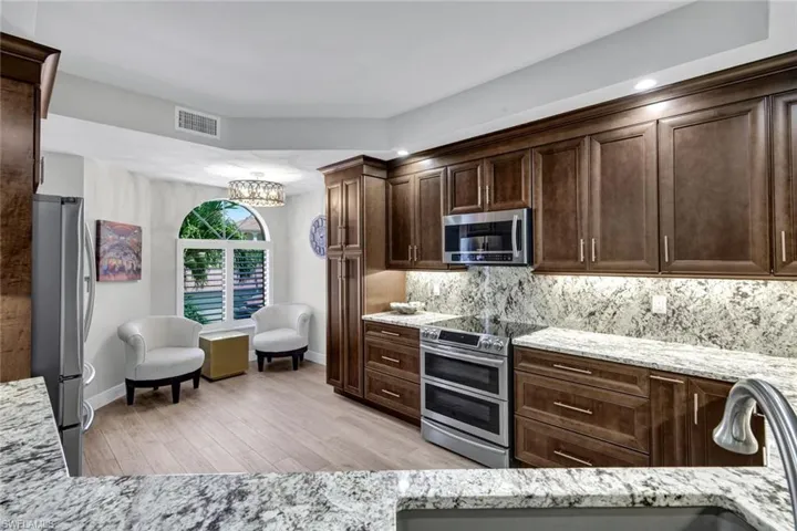 Kitchen featuring wood-finish cabinetry, granite countertops, and stainless steel appliances