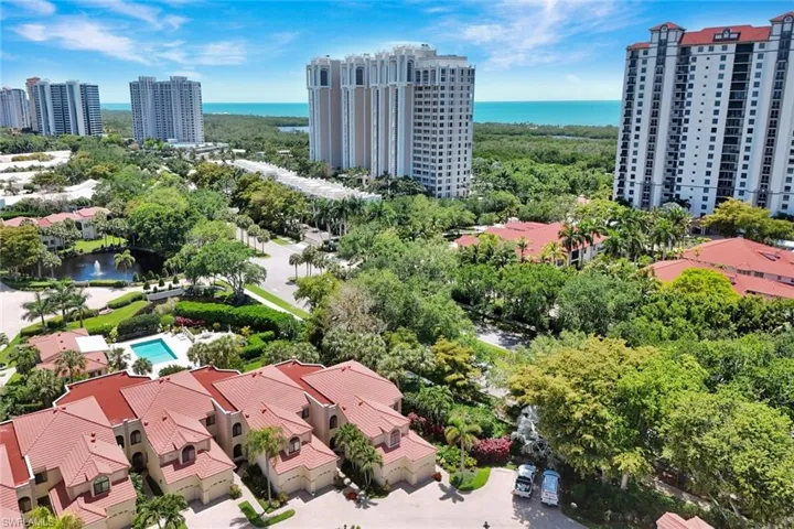 Extensive coastal community featuring mature landscaping, a private pool, and a pond with a fountain