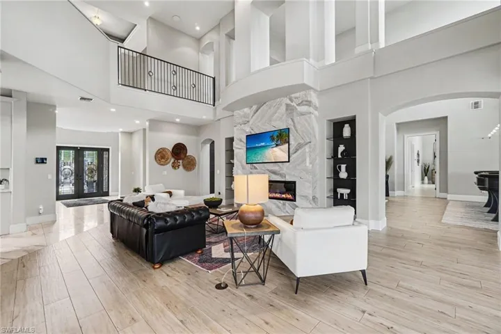 Spacious open-concept interior featuring high ceilings and wood-finish flooring