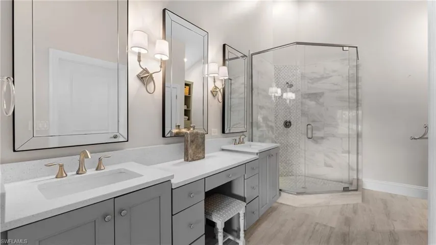 Primary Bathroom with double vanities, frameless mirrors and gorgeous sconces!
