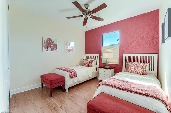 Bedroom with ceiling fan and light hardwood / wood-style floors