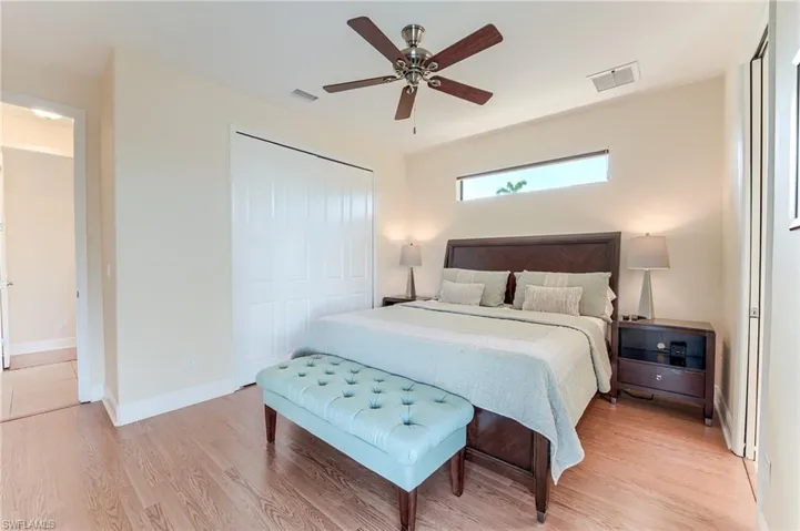 Bedroom with ceiling fan and light hardwood / wood-style floors