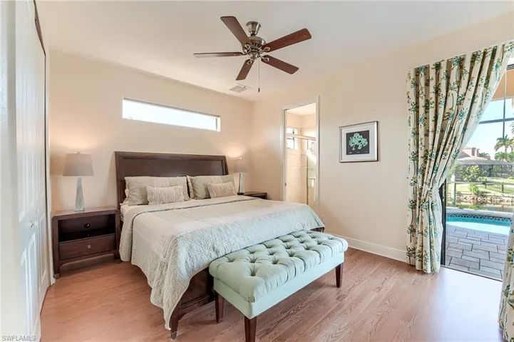 Bedroom featuring a closet, multiple windows, ceiling fan, and light hardwood / wood-style flooring
