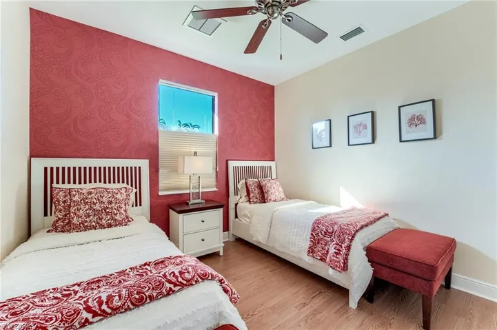 Bedroom with ceiling fan and light wood-type flooring