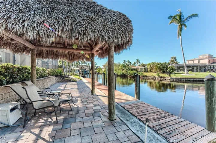 Dock area featuring a gazebo, glass enclosure, and a patio area