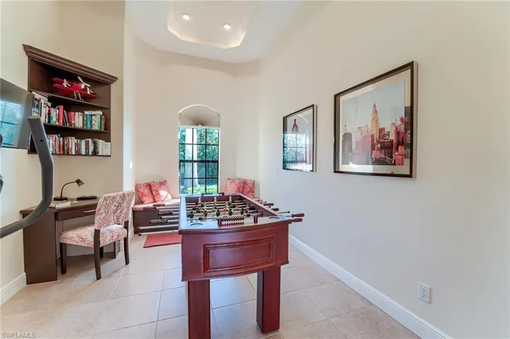 Tiled office featuring a tray ceiling
