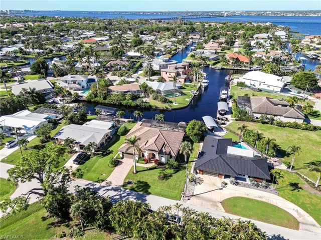 Birds eye view of property with a water view