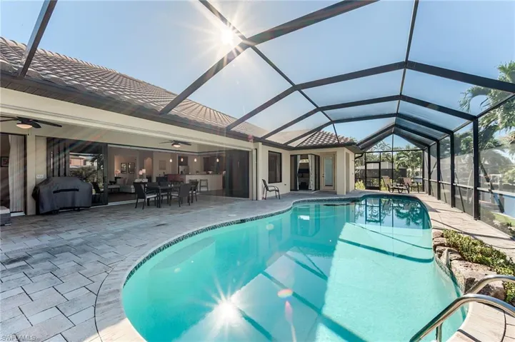 View of patio / terrace with glass enclosure, ceiling fan, a water view, and an outdoor hangout area