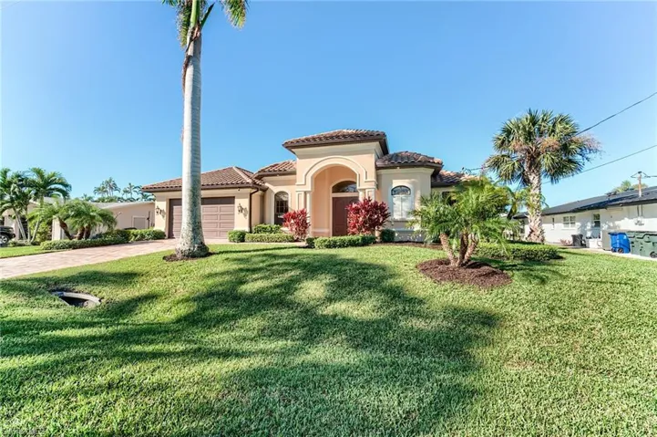 View of property exterior featuring a garage, central air condition unit, and a lawn