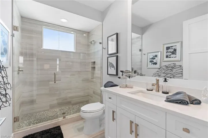 Full bath with vanity, a shower stall, recessed lighting, and light wood-type flooring