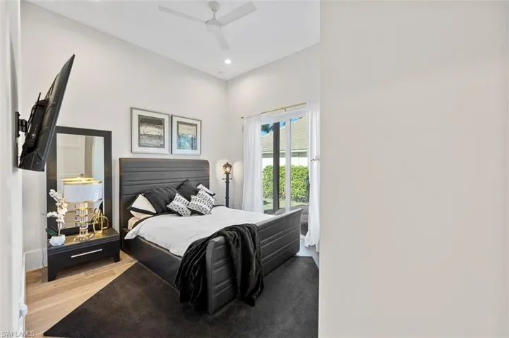 Bedroom featuring wood finished floors, a ceiling fan, access to exterior, and recessed lighting