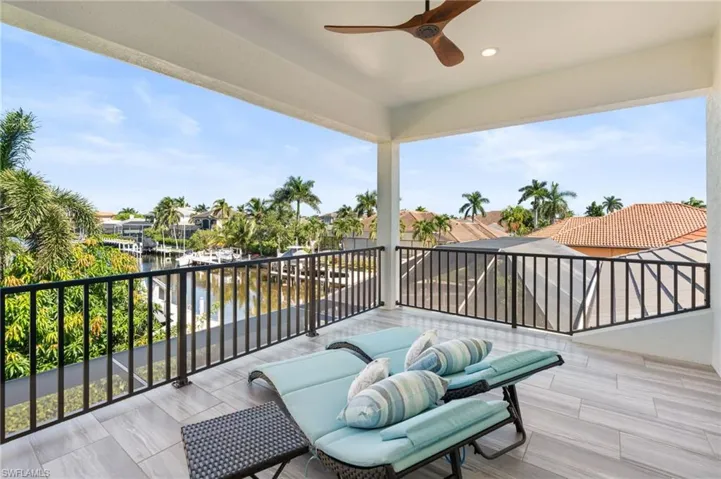 Balcony with a ceiling fan and a water view
