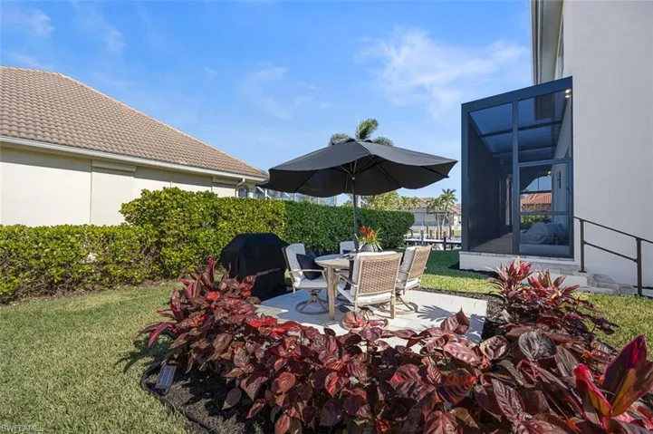 View of patio / terrace with area for grilling, a sunroom, and outdoor dining area
