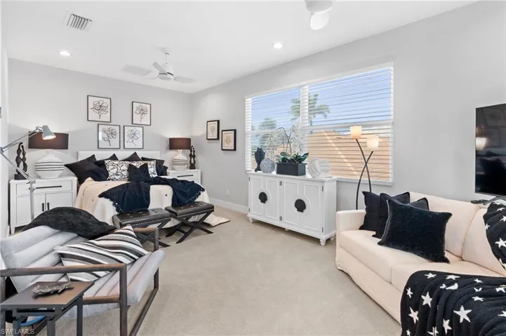 Living area with carpet, recessed lighting, and ceiling fan