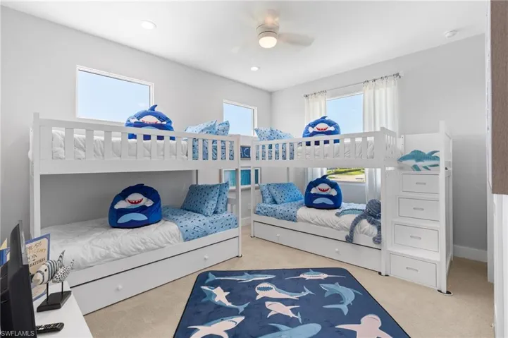 Bedroom with light colored carpet, a ceiling fan, and recessed lighting