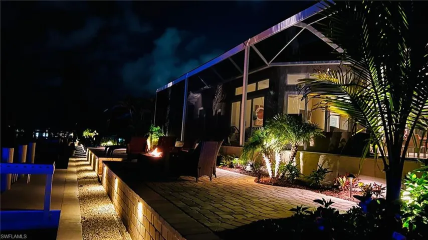 Deck at night with a patio area and a lanai