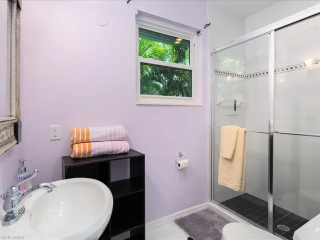 Full bath featuring a shower stall