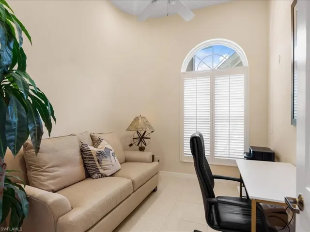 Office area featuring light tile patterned floors and a ceiling fan