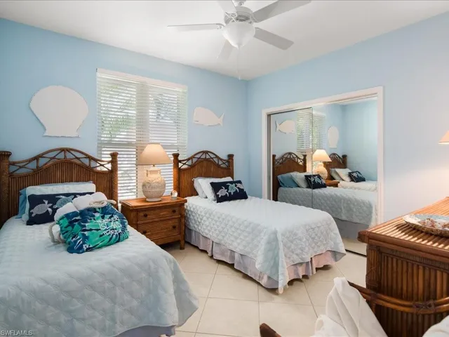Bedroom featuring light tile patterned flooring and ceiling fan