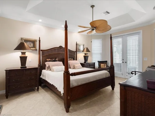 Bedroom with crown molding, french doors, light tile patterned floors, access to outside, and a ceiling fan