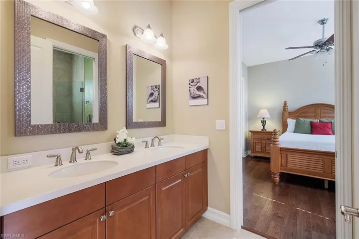 Renovated Jack-n-Jill Bath with Dual Sinks and Frameless Walk-In Shower