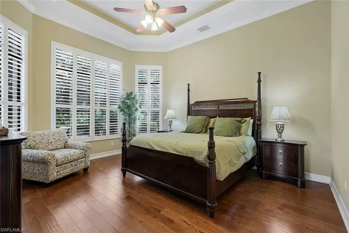 Owner's Suite with Tray Ceiling, Warm Wood Floor and Plantation Shutters