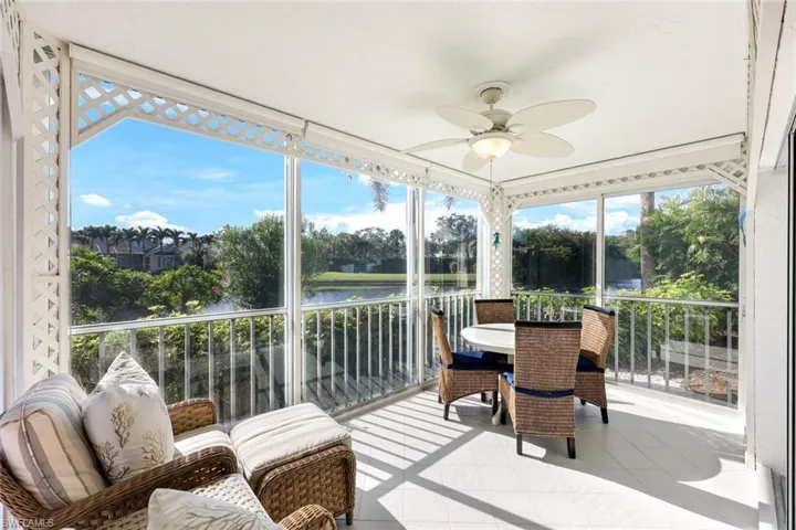 Sunroom / solarium featuring ceiling fan, a water view, outdoor dining area, and a balcony