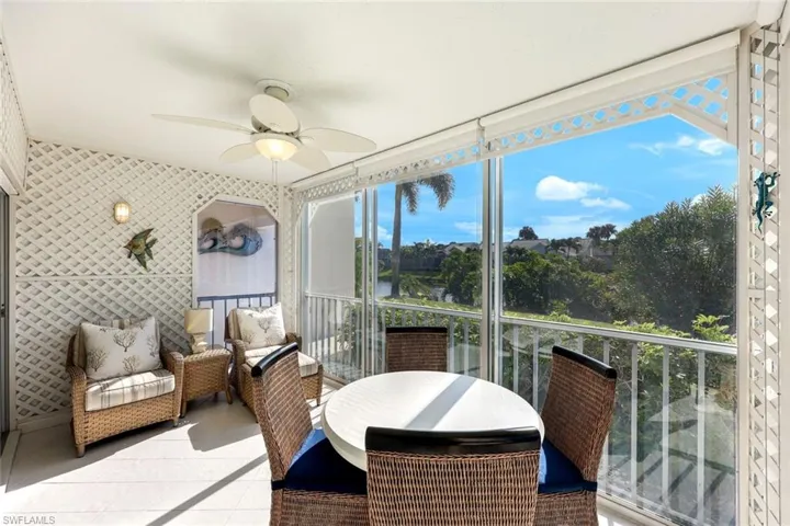 Sunroom / solarium featuring ceiling fan and a balcony