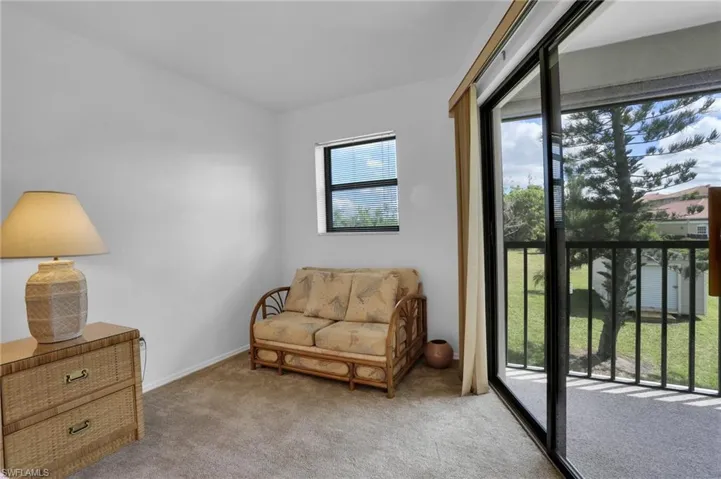 Sitting room with baseboards and light colored carpet