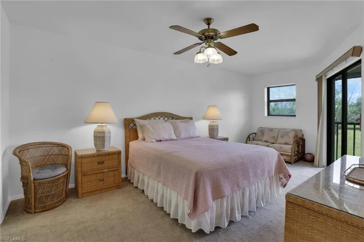 Bedroom with light carpet, access to exterior, and ceiling fan