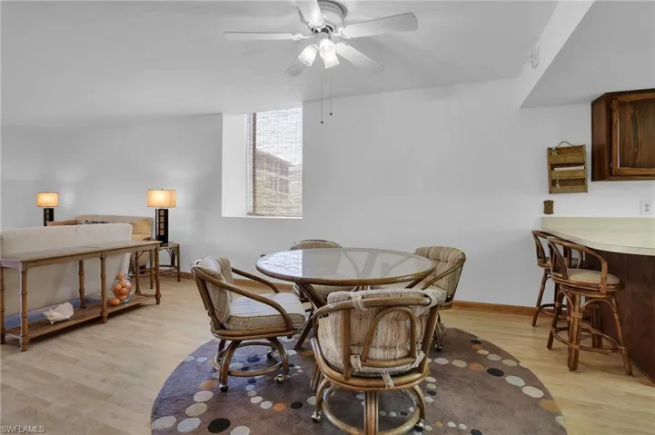 Dining room featuring a ceiling fan, light wood-style flooring, and baseboards