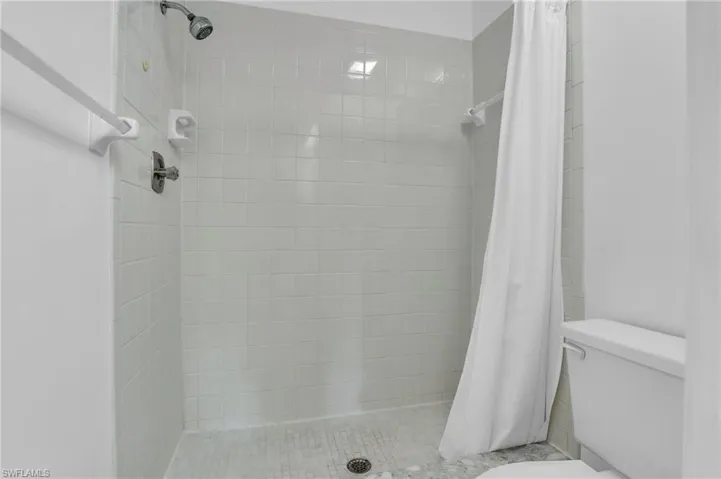 Bathroom with toilet and a shower stall