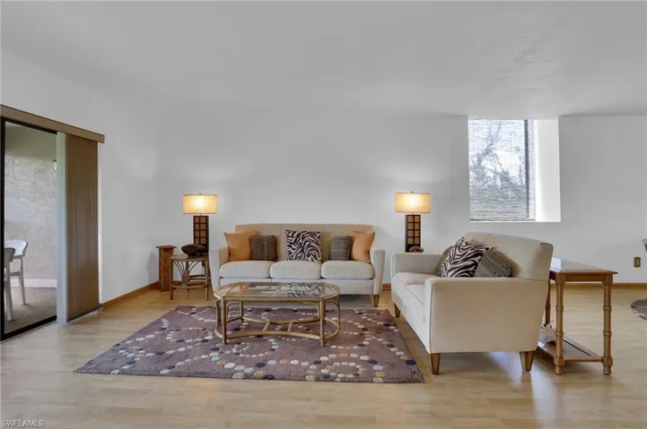 Living area with baseboards and wood finished floors