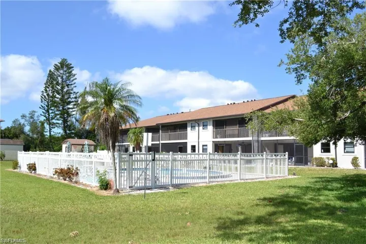 View of pool with a yard, fence, and a fenced in pool