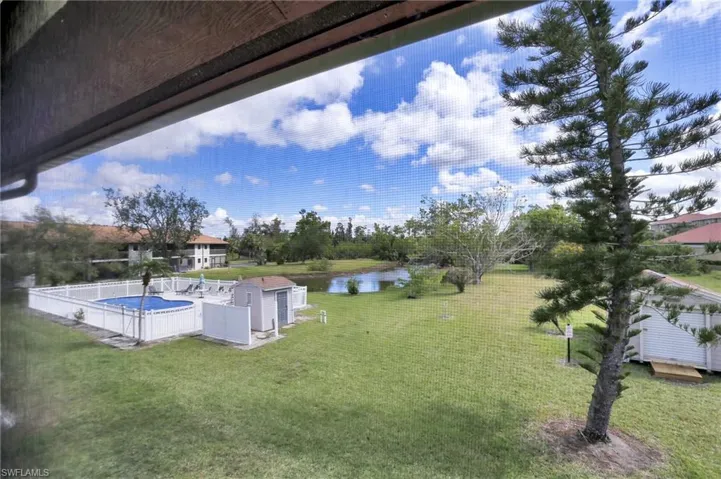 View of yard featuring a water view and a fenced in pool