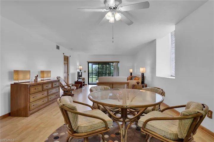 Dining space featuring light wood finished floors, ceiling fan, visible vents, and baseboards