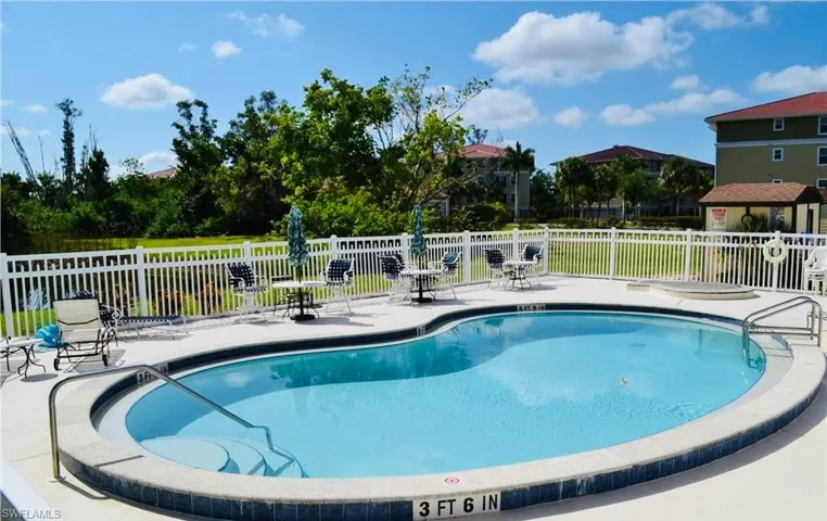 Community pool with a patio
