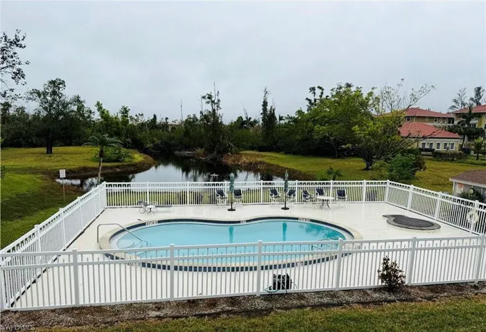 View of pool with a patio area and a water view