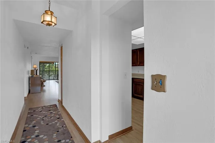 Hall featuring light wood-type flooring and baseboards