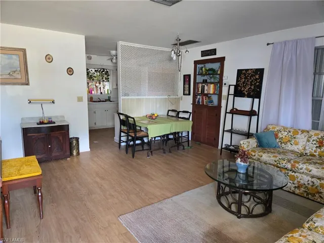 Living room with visible vents and light wood finished floors